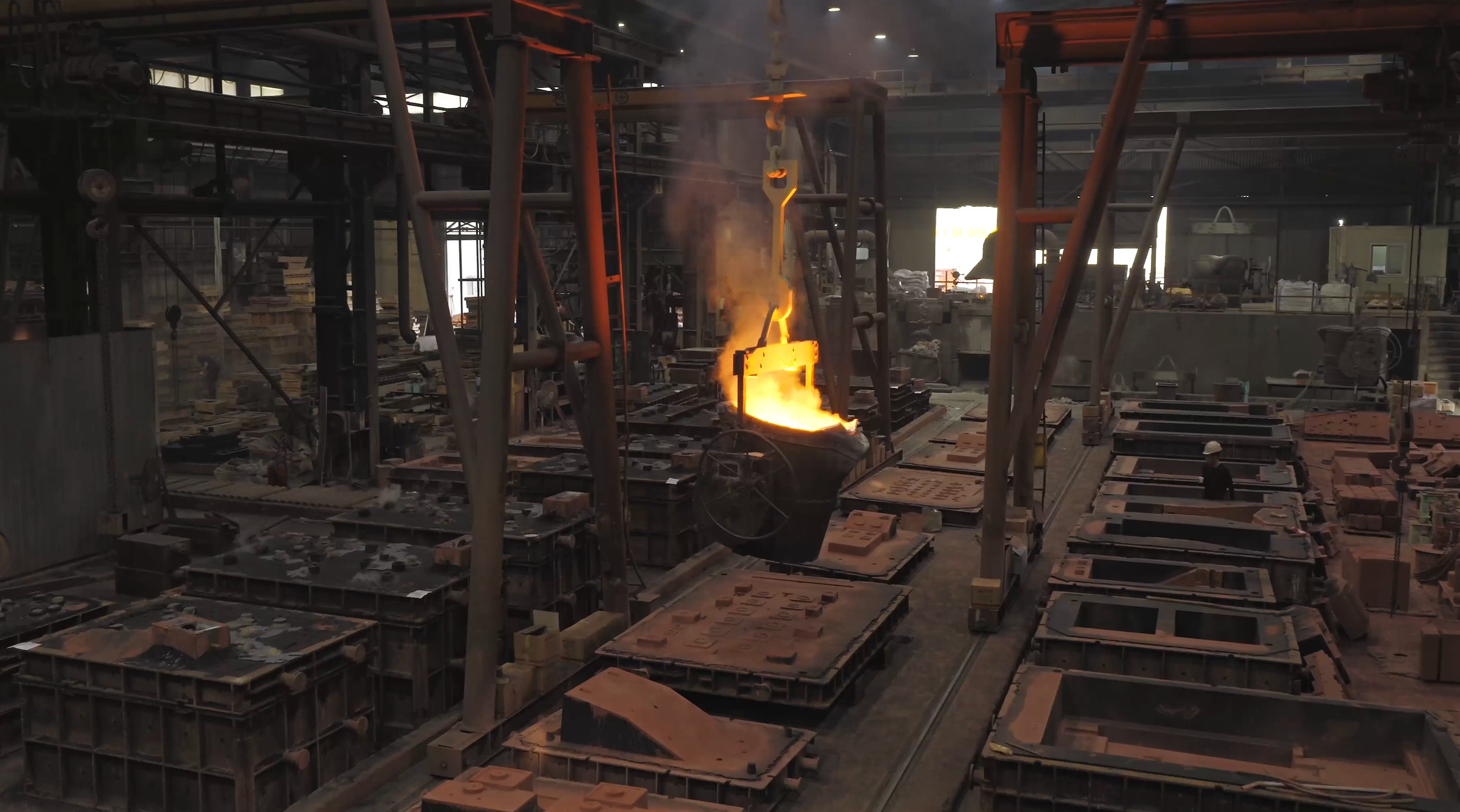Inside the KMT foundry, a ladle of molten iron on the crane